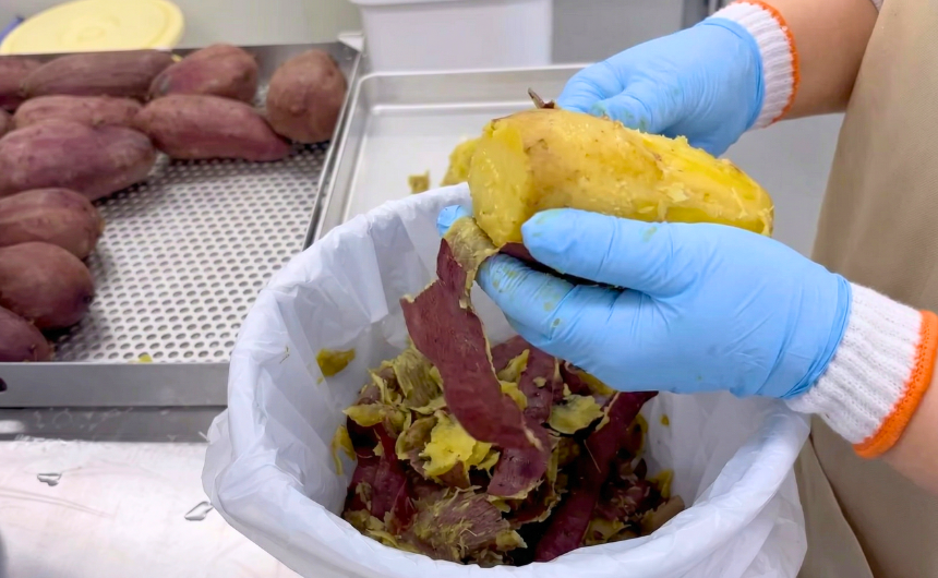 さつまいもを一つひとつ手作業で丁寧に皮むきしている様子